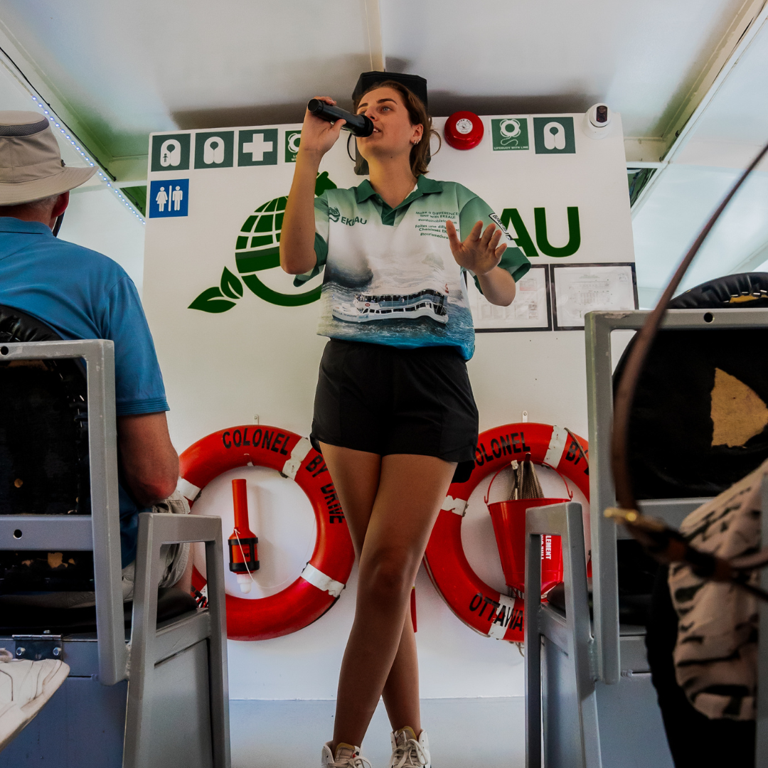 a tour guide giving a tour on the 100 Percent Electric UNESCO Canal Cruise
