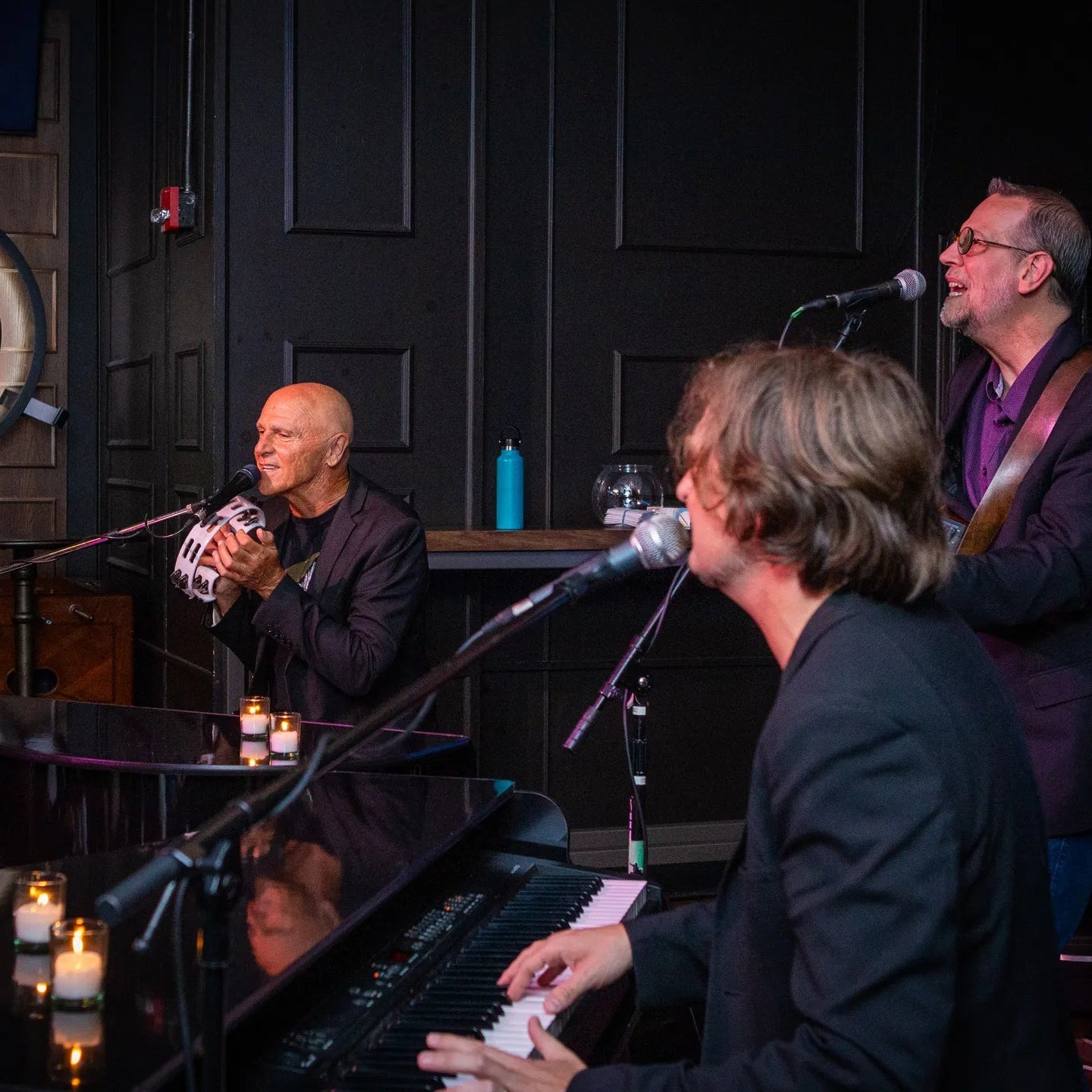 Dueling Pianos Cruise performance by musicians at Hull Marina with candles on stage.